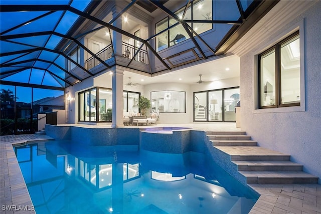 view of swimming pool featuring a lanai, a patio, ceiling fan, and an in ground hot tub