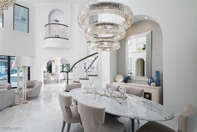 dining space featuring a high ceiling and an inviting chandelier