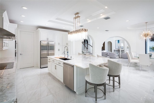 kitchen featuring sink, white cabinets, a spacious island, and appliances with stainless steel finishes