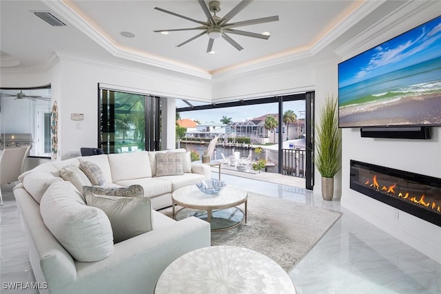 living room featuring crown molding, a tray ceiling, and ceiling fan