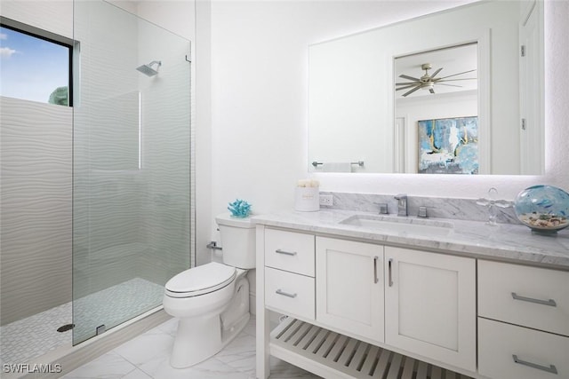 bathroom featuring vanity, toilet, and a tile shower