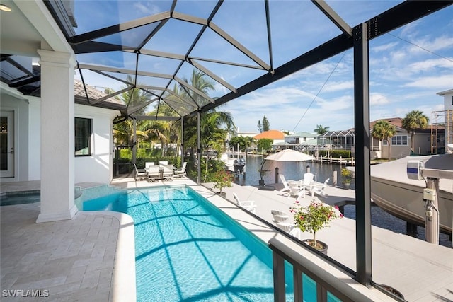 view of swimming pool featuring a lanai, a patio, and a water view