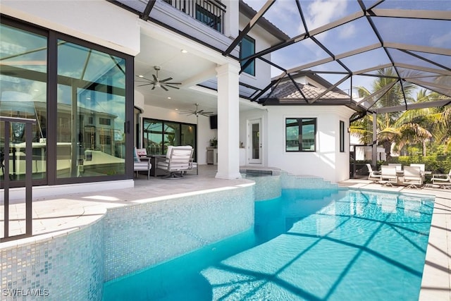 view of pool featuring a lanai, a patio, and ceiling fan