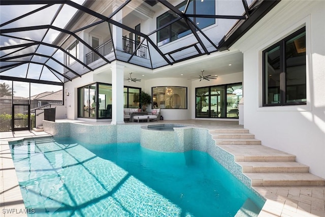 view of swimming pool with outdoor lounge area, a patio, ceiling fan, and glass enclosure