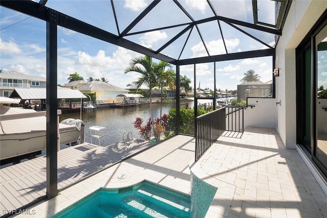 view of patio featuring glass enclosure and a water view