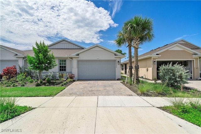 ranch-style house featuring a garage, driveway, and stucco siding