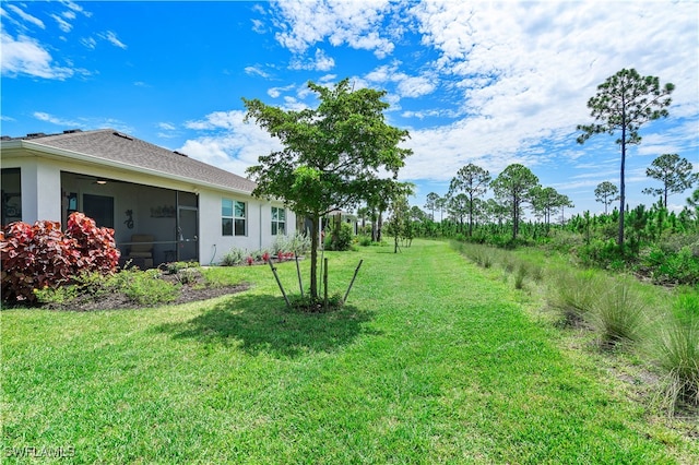 view of yard with a sunroom