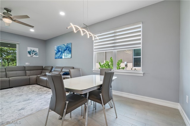 dining room with light hardwood / wood-style flooring, a healthy amount of sunlight, and ceiling fan