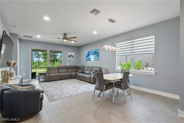 living room with a healthy amount of sunlight, light wood-type flooring, and ceiling fan