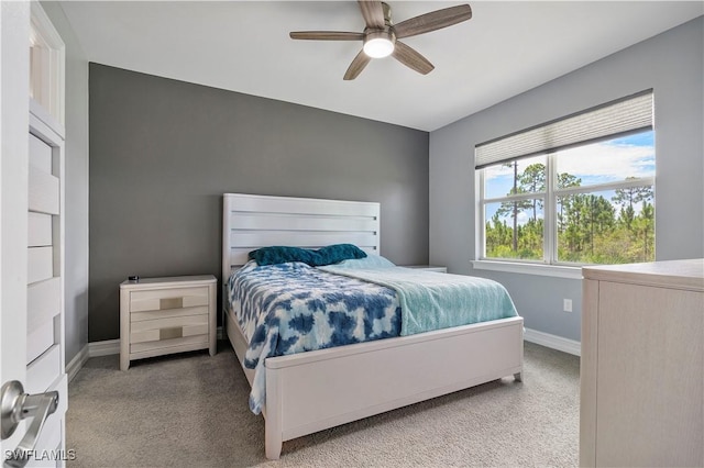 carpeted bedroom with ceiling fan and baseboards