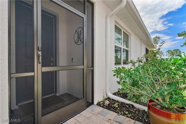 property entrance featuring stucco siding