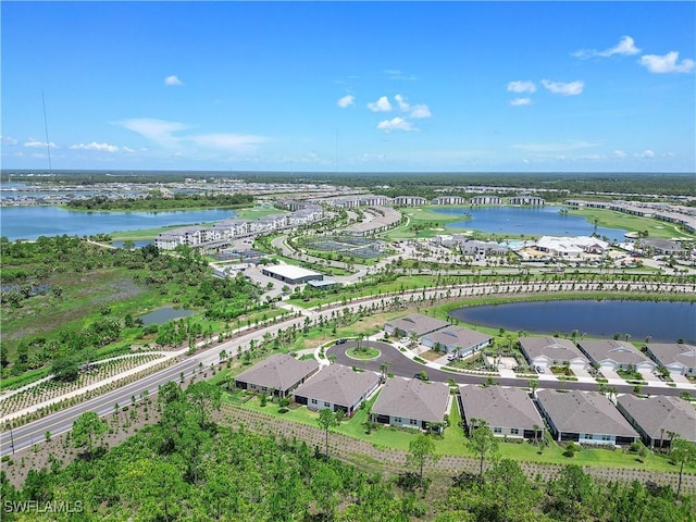 birds eye view of property featuring a water view and a residential view