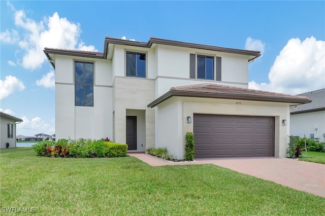 view of front facade featuring a garage and a front lawn