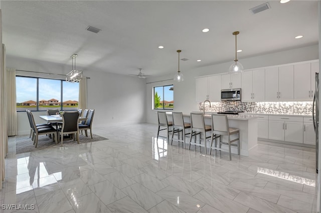 dining space featuring ceiling fan