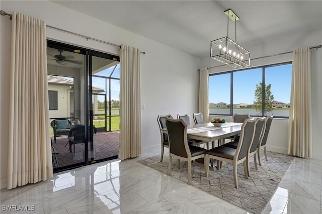 dining area featuring ceiling fan with notable chandelier and a wealth of natural light