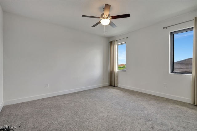 spare room with light carpet and ceiling fan