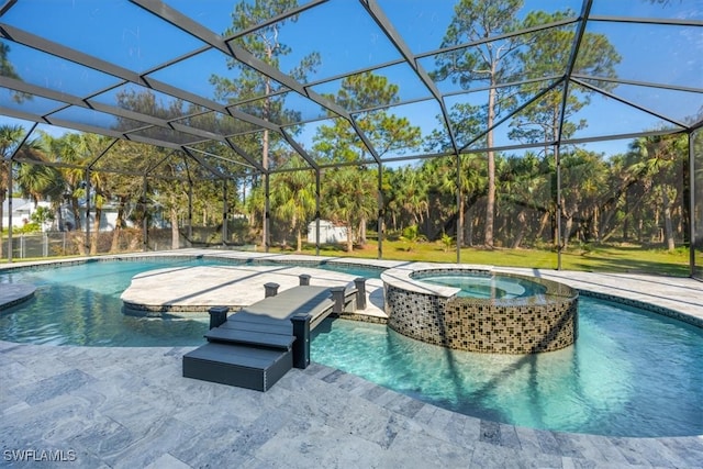 view of pool featuring a lanai and an in ground hot tub