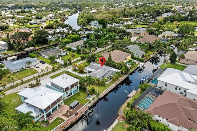 drone / aerial view featuring a residential view and a water view