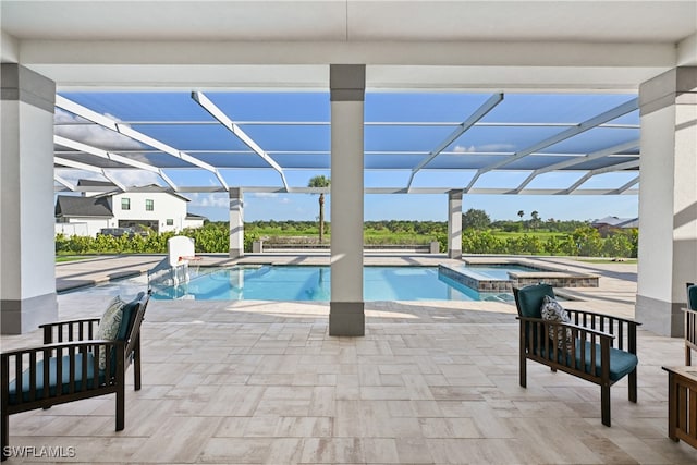 view of pool featuring a patio, an in ground hot tub, and glass enclosure