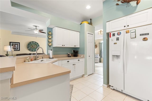 kitchen with kitchen peninsula, sink, white refrigerator with ice dispenser, and white cabinets