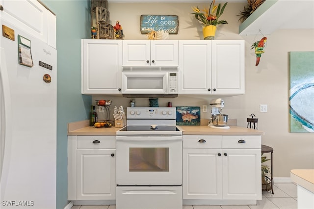 kitchen featuring white cabinets, white appliances, and light tile patterned floors