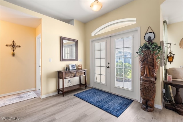 entryway with light hardwood / wood-style floors and french doors