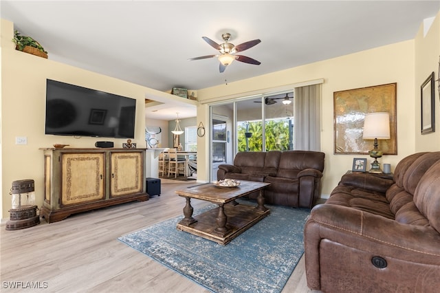 living room featuring ceiling fan and light hardwood / wood-style flooring