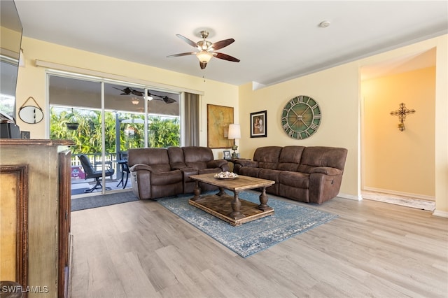 living room with ceiling fan and light hardwood / wood-style floors