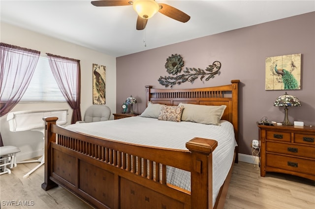 bedroom with ceiling fan and light hardwood / wood-style flooring