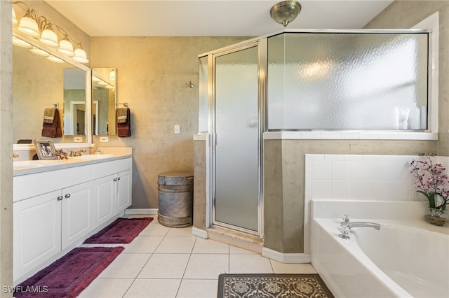 bathroom featuring tile patterned flooring, vanity, and plus walk in shower