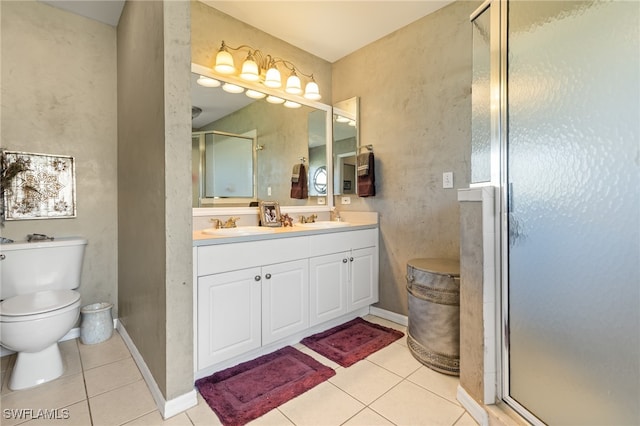 bathroom with tile patterned floors, an enclosed shower, vanity, and toilet