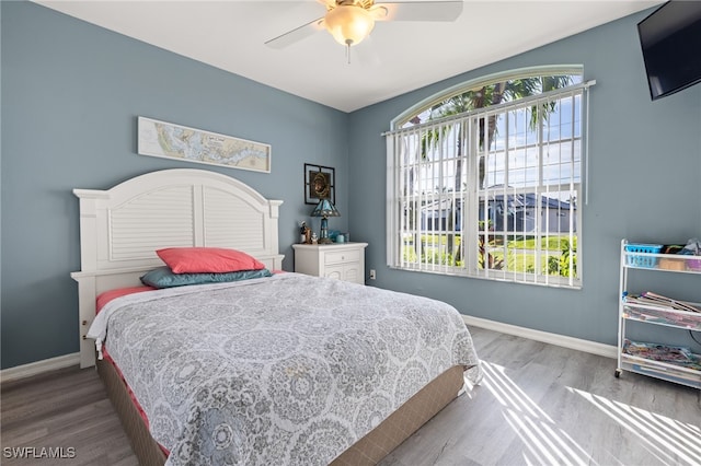 bedroom with ceiling fan and hardwood / wood-style floors