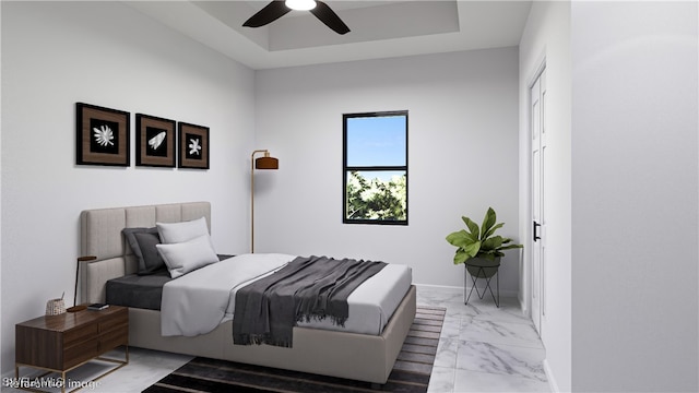 tiled bedroom featuring ceiling fan and a raised ceiling