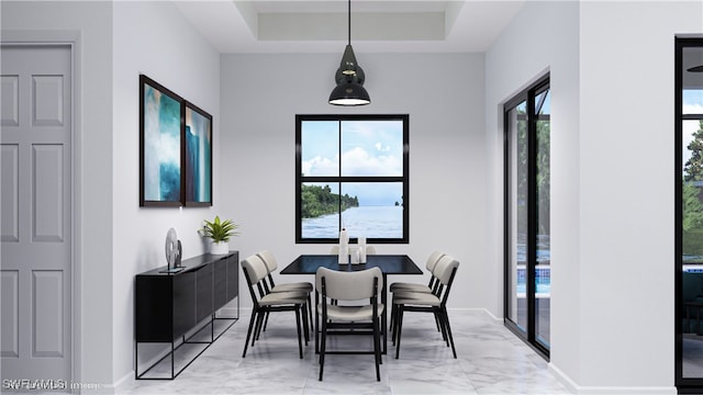 dining room with a raised ceiling, light tile patterned floors, and a healthy amount of sunlight