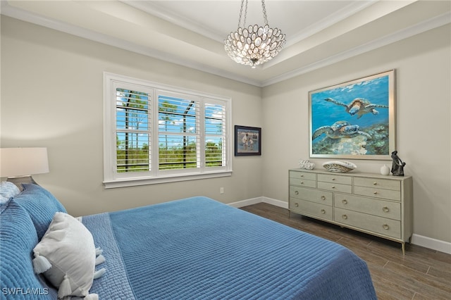 bedroom featuring a chandelier, a raised ceiling, and ornamental molding