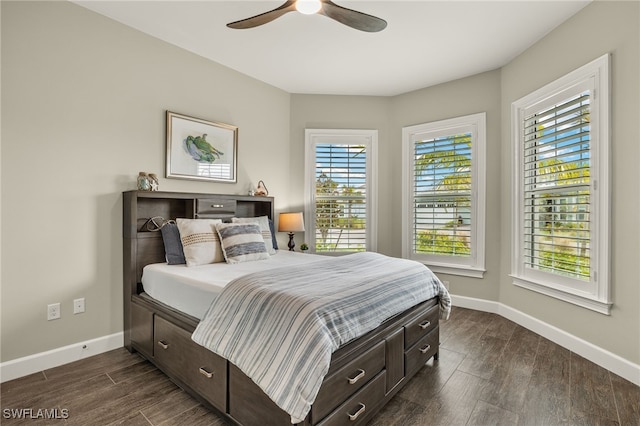 bedroom with ceiling fan and dark hardwood / wood-style flooring