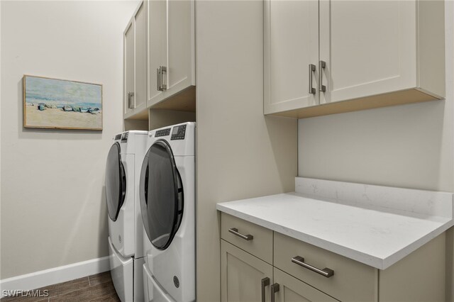 washroom featuring cabinets and washing machine and clothes dryer