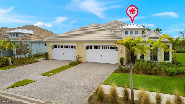 view of front of house featuring a garage and a front lawn