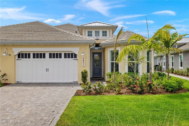 view of front of home featuring a garage and a front lawn