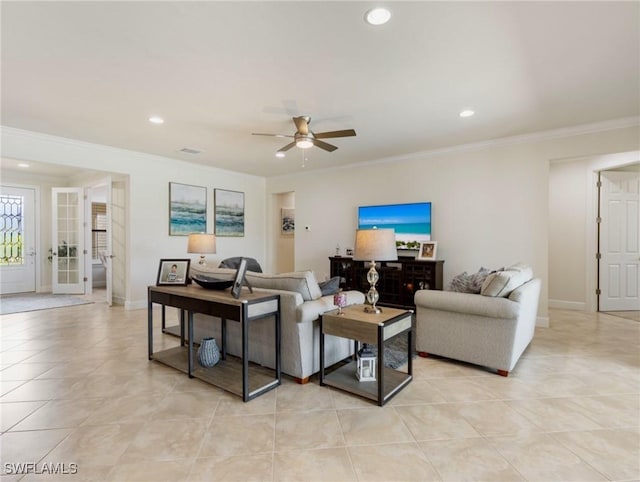 tiled living room with ceiling fan and ornamental molding