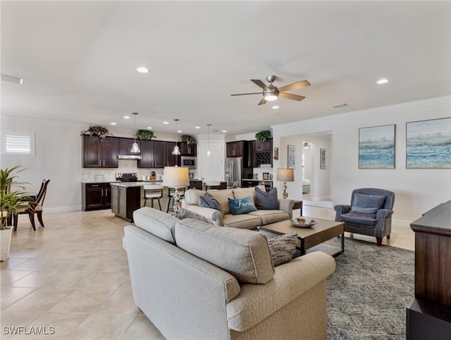 living room with light tile patterned flooring, ceiling fan, and crown molding