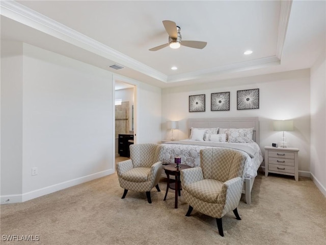 bedroom with connected bathroom, ornamental molding, light colored carpet, ceiling fan, and a raised ceiling