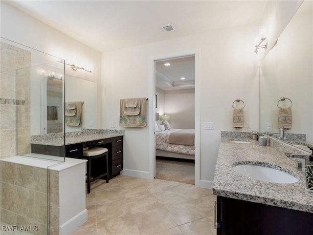 bathroom with vanity and a tile shower