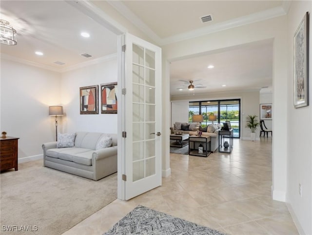 living room with french doors, light colored carpet, ornamental molding, and ceiling fan