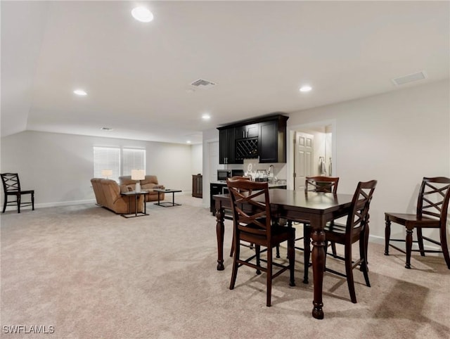 dining room with light colored carpet