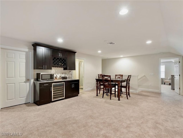 bar featuring light carpet and beverage cooler