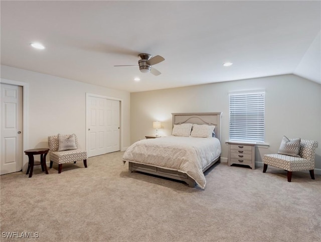 carpeted bedroom with ceiling fan and vaulted ceiling