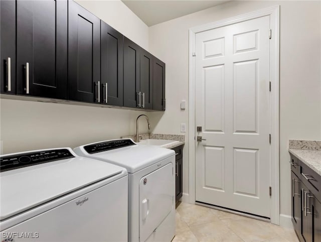 laundry area with cabinets, independent washer and dryer, sink, and light tile patterned floors