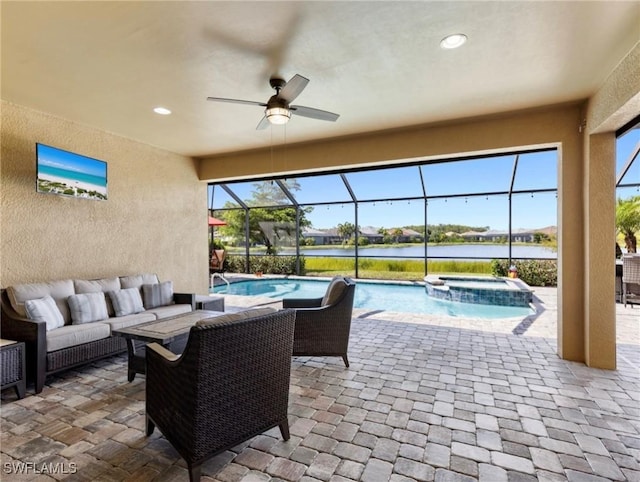 view of patio / terrace with a swimming pool with hot tub, an outdoor hangout area, ceiling fan, glass enclosure, and a water view