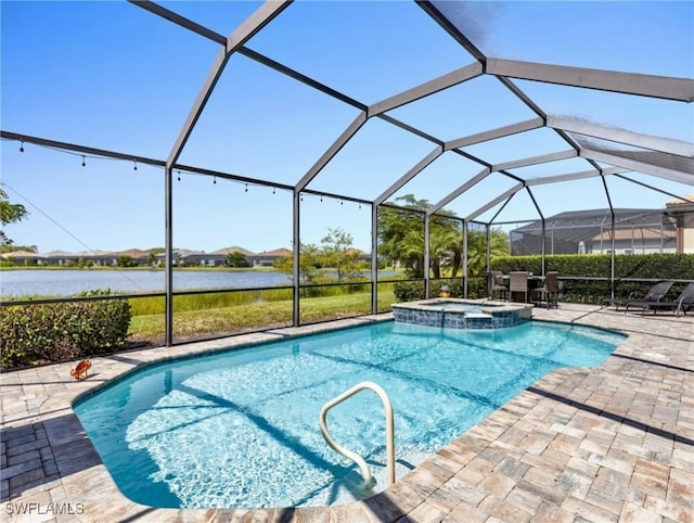 view of swimming pool with an in ground hot tub, a water view, glass enclosure, and a patio